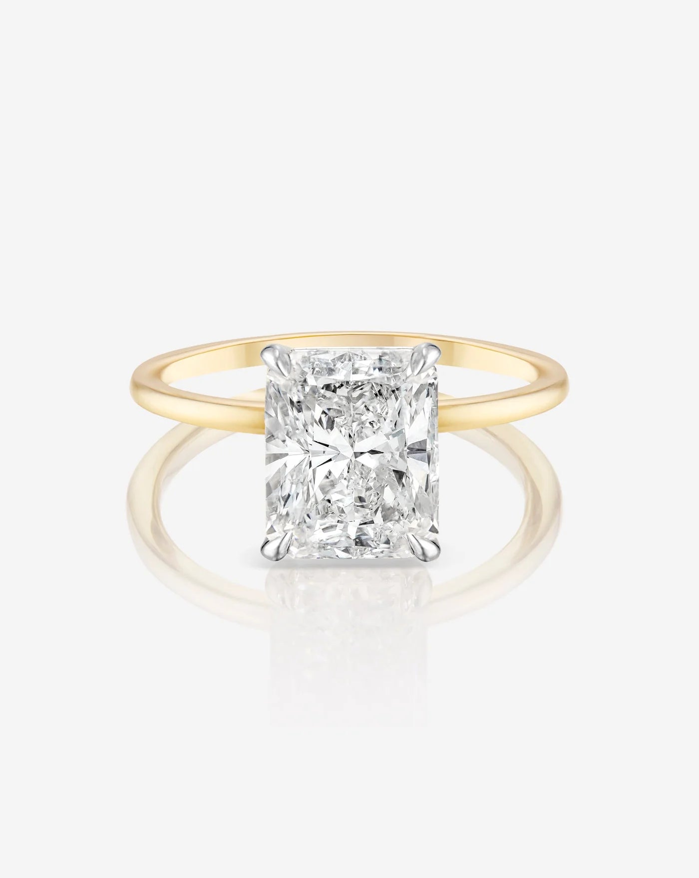 The image shows a front view of the radiant cut diamond showing it’s cut in close detail, set on a 14kt hallmark yellow gold band
