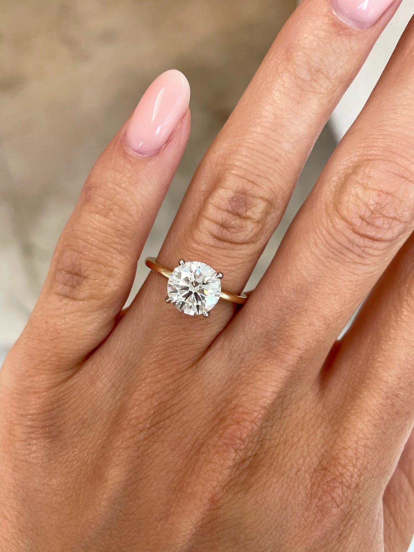 2 carat lab diamond solitaire ring in 14kt hallmark yellow gold band set in a classic 4 prong setting. The image showcases a close up of the diamond, it’s cut and clarity.