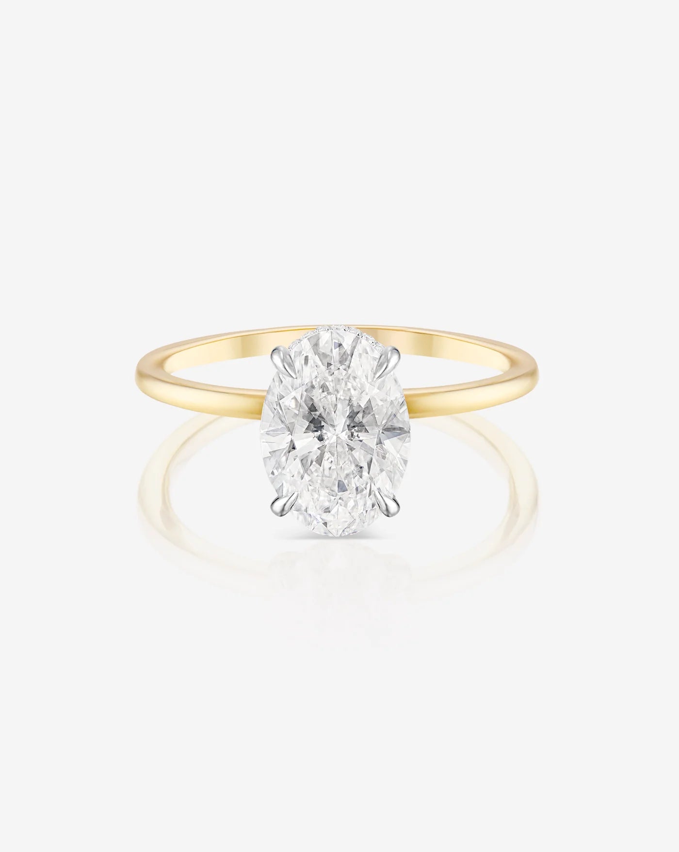 The image shows the front profile of a 2 carat oval shape lab diamond solitaire ring set in 14kt hallmark yellow gold band