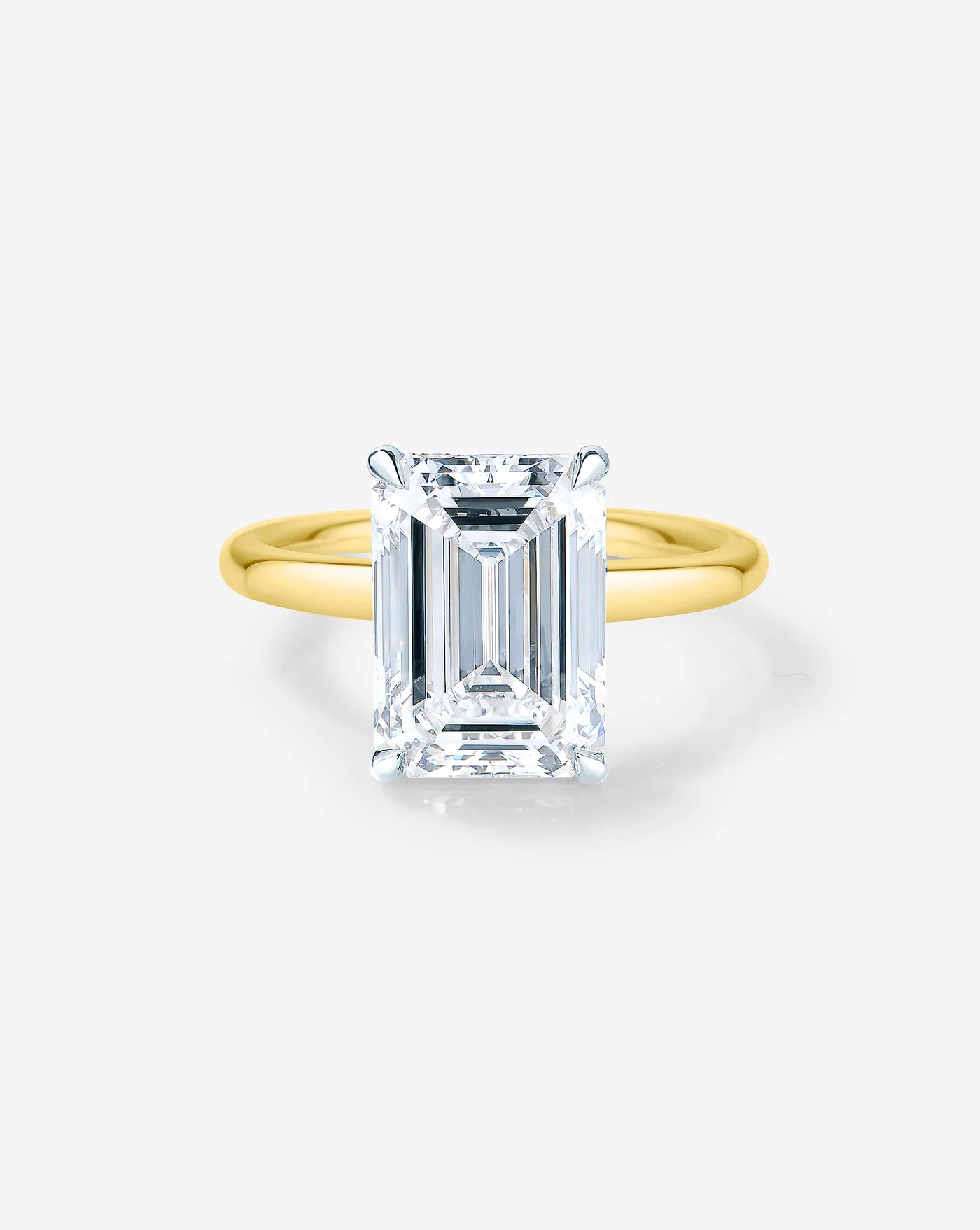 3.4 ct emerald cut lab diamond solitaire ring set in 14kt yellow gold.