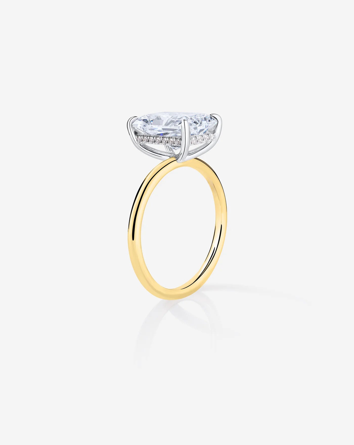 4 carat radiant lab diamond solitaire ring in a old band set with classic prong setting, viewed in this image from the side