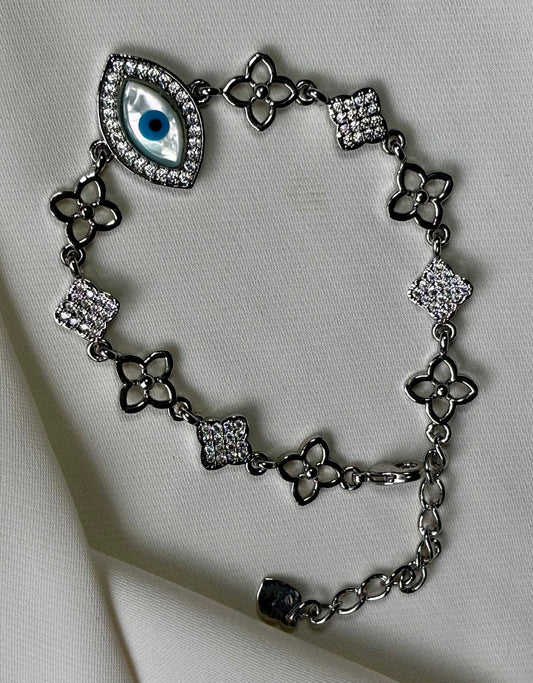 Evil eye bracelet made in 92.5 sterling silver with rhodium plating and moissanite stones. Anti- tarnish and waterproof.