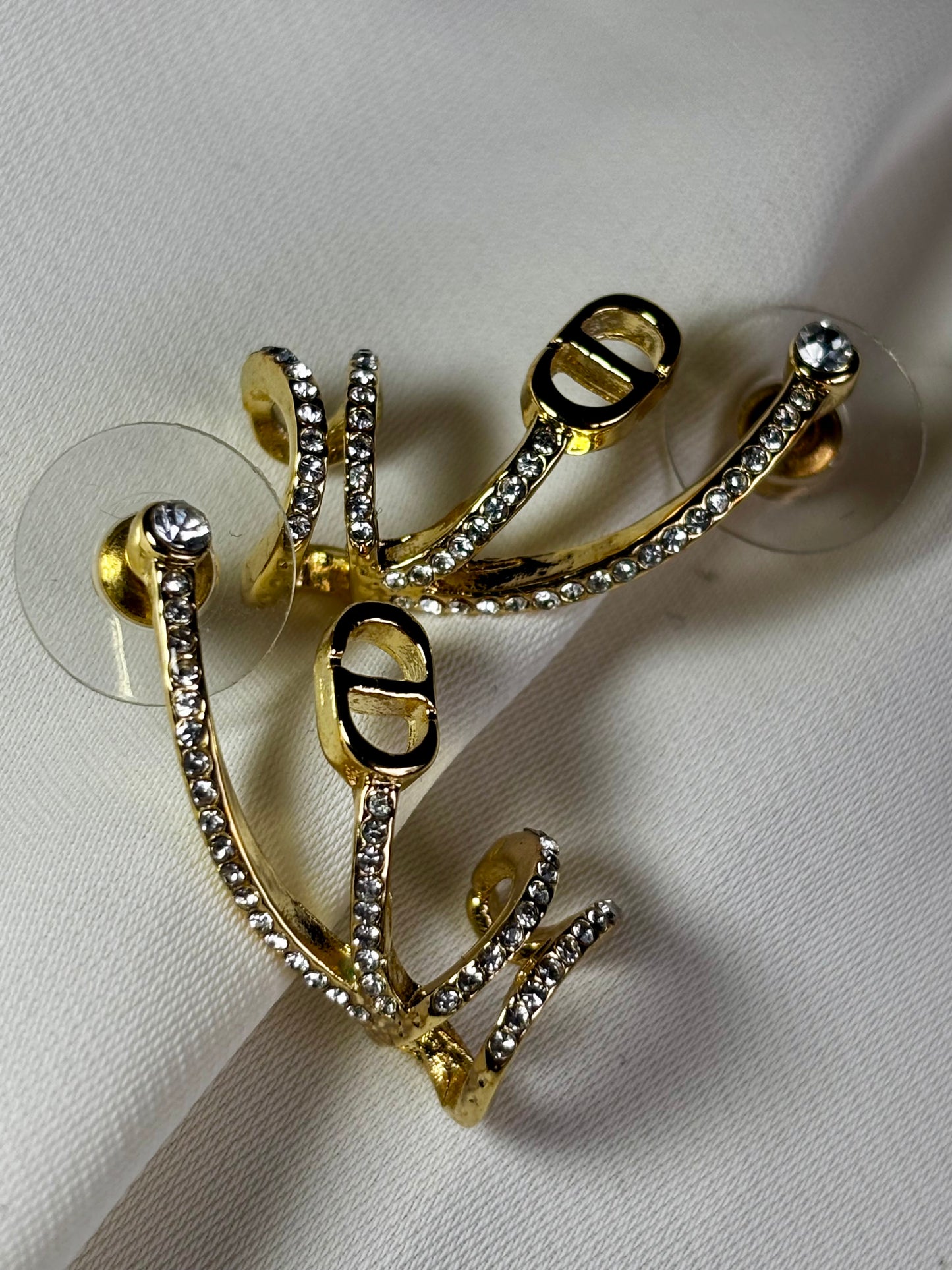 Cd logo earrings made in 92.5 Sterling silver with 18kt gold plating and moissanite stones