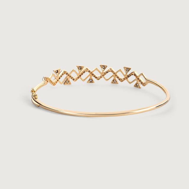The image shows the backside of a geometric pattern of lab diamond and gold bangle