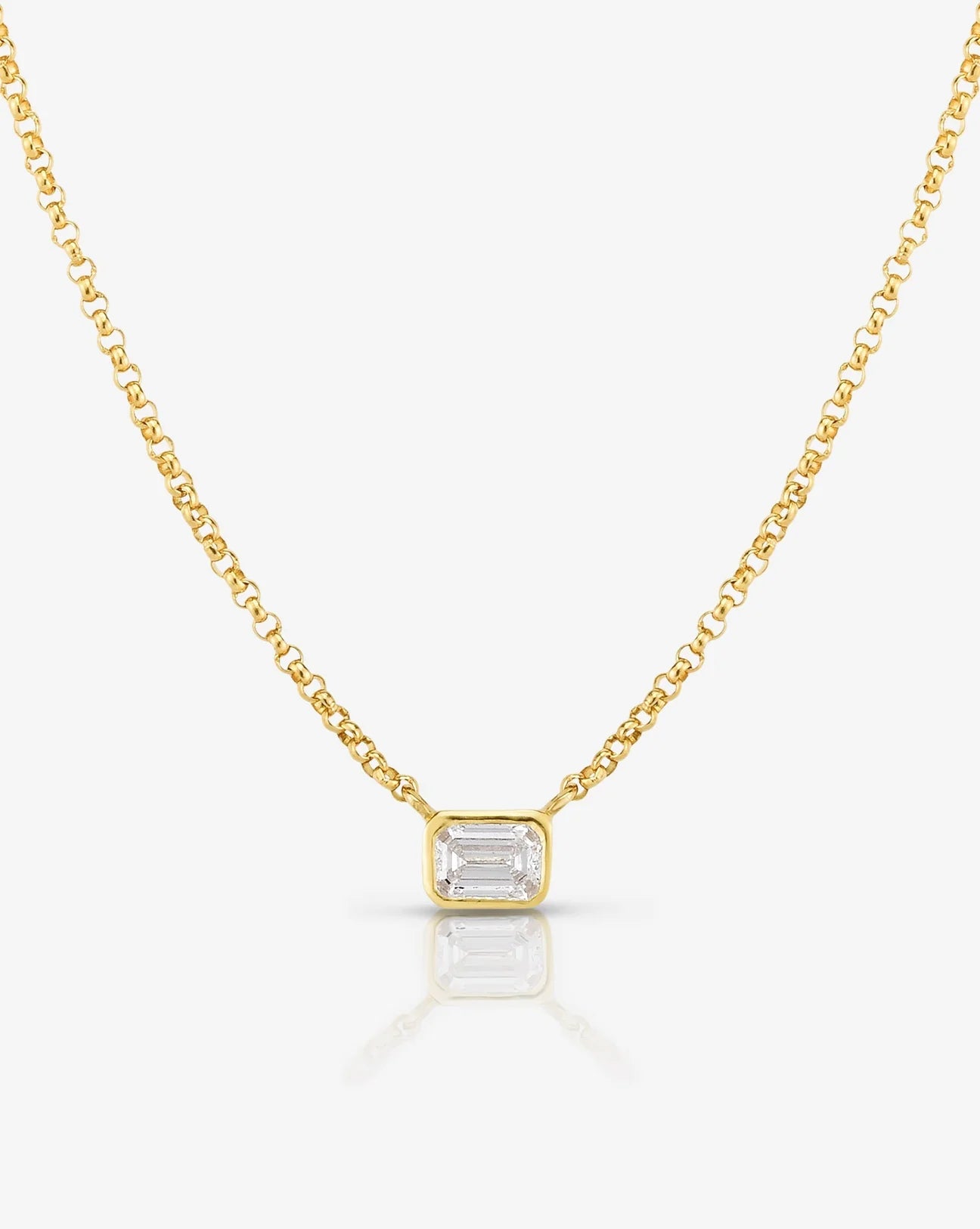 Half carat emerald shape diamond in bezel setting on a sleek 9kt hallmark yellow gold chain.