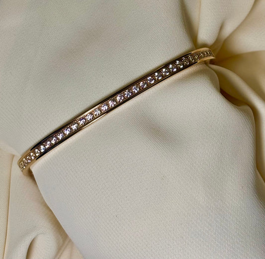 Close up of the moissanite stones in a rose gold tone bangle made with 92.5 sterling silver, and 18 carat rose gold plating. Anti tarnish and waterproof.