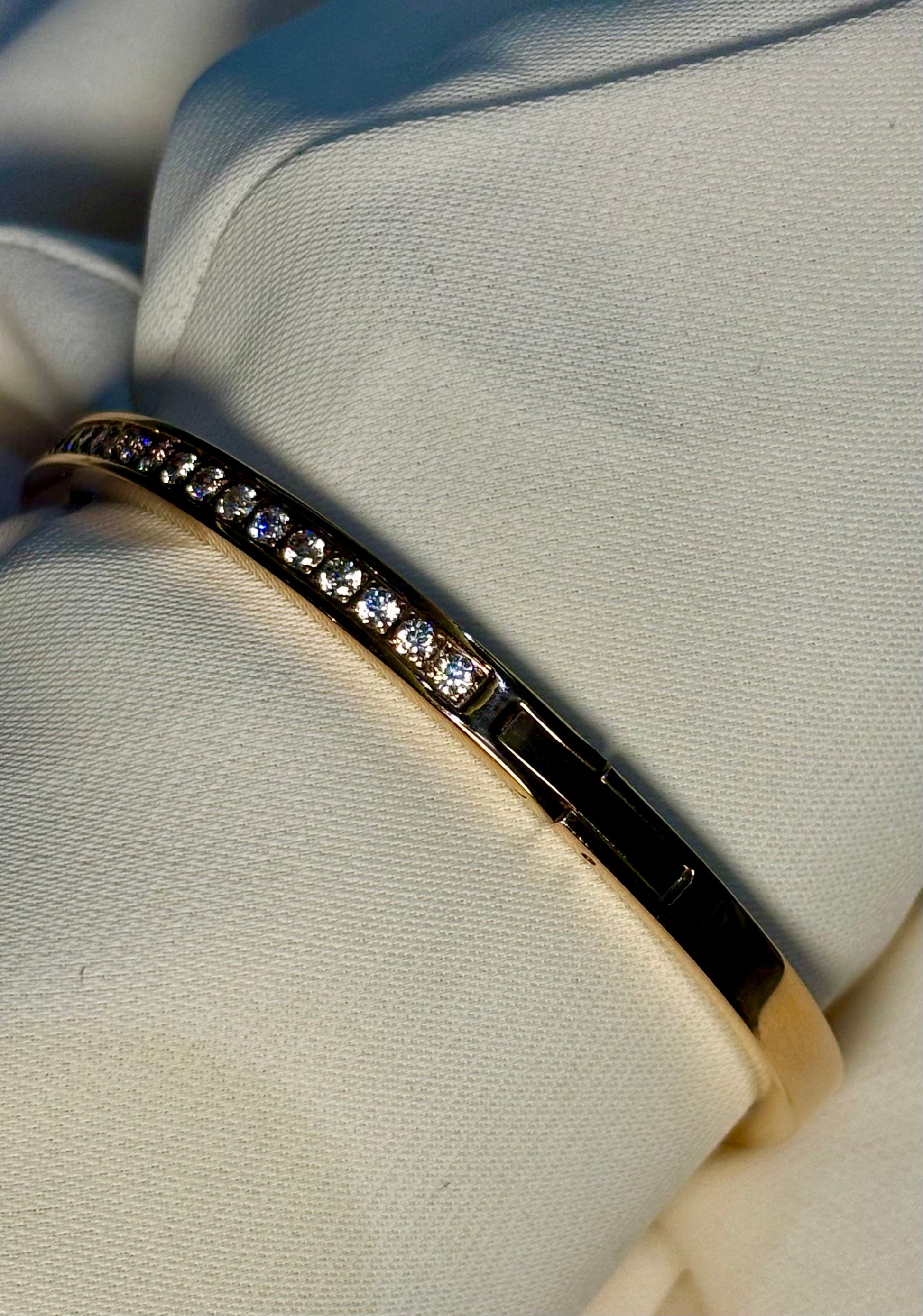 Sleek Half eternity, moissanite stones and sterling silver bangle with 18 carat rose gold plating. Anti tarnish and waterproof.
