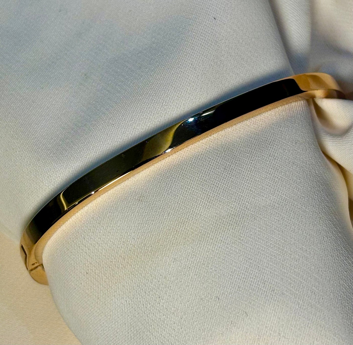Sleek, half eternity rose gold tone bangle made with 92.5 sterling silver and 18 carat rose gold plating. Anti tarnish and waterproof.