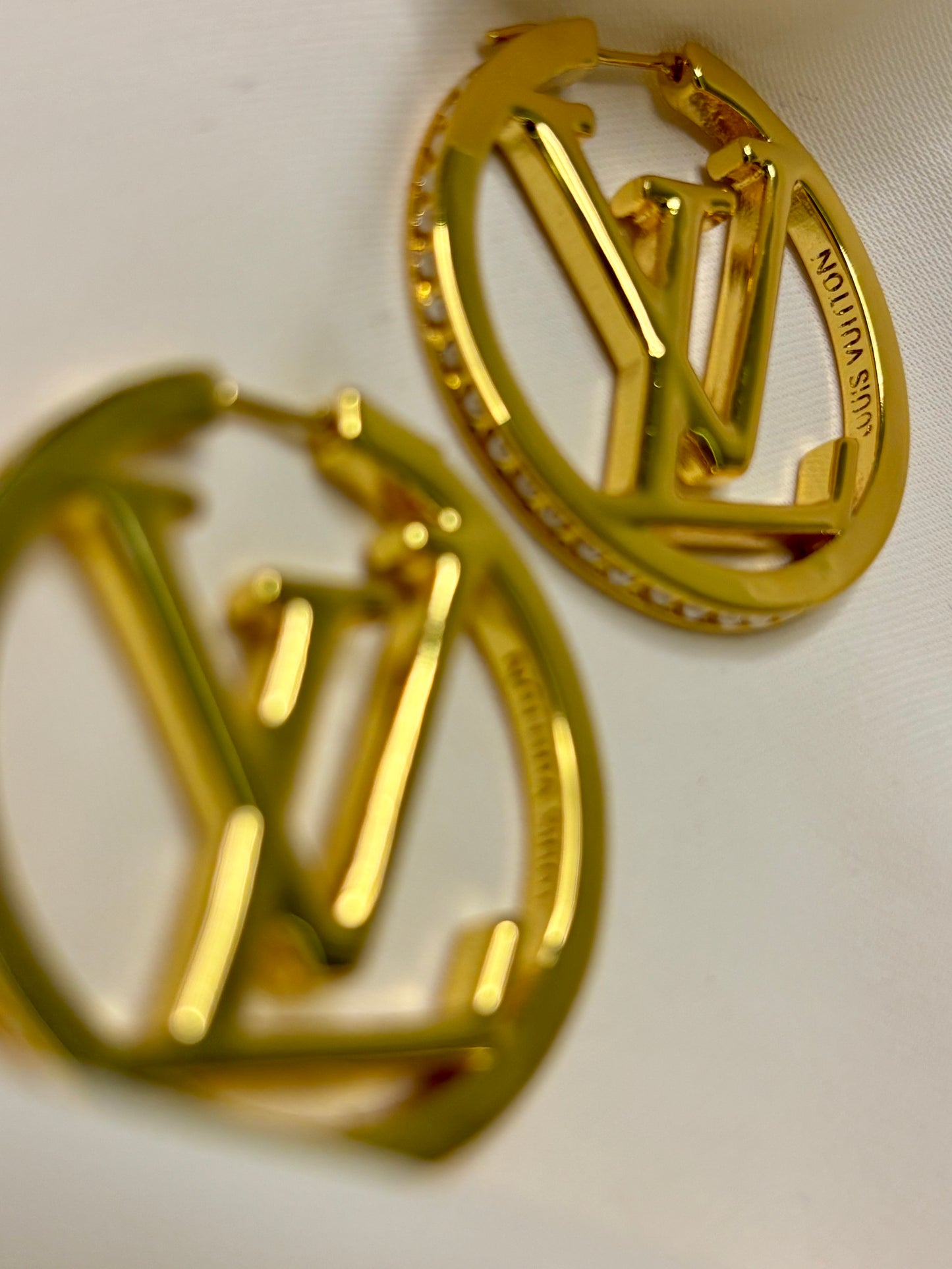 Initial hoop earrings made with 92.5 sterling silver with 18 karat gold plating and moissanite stones