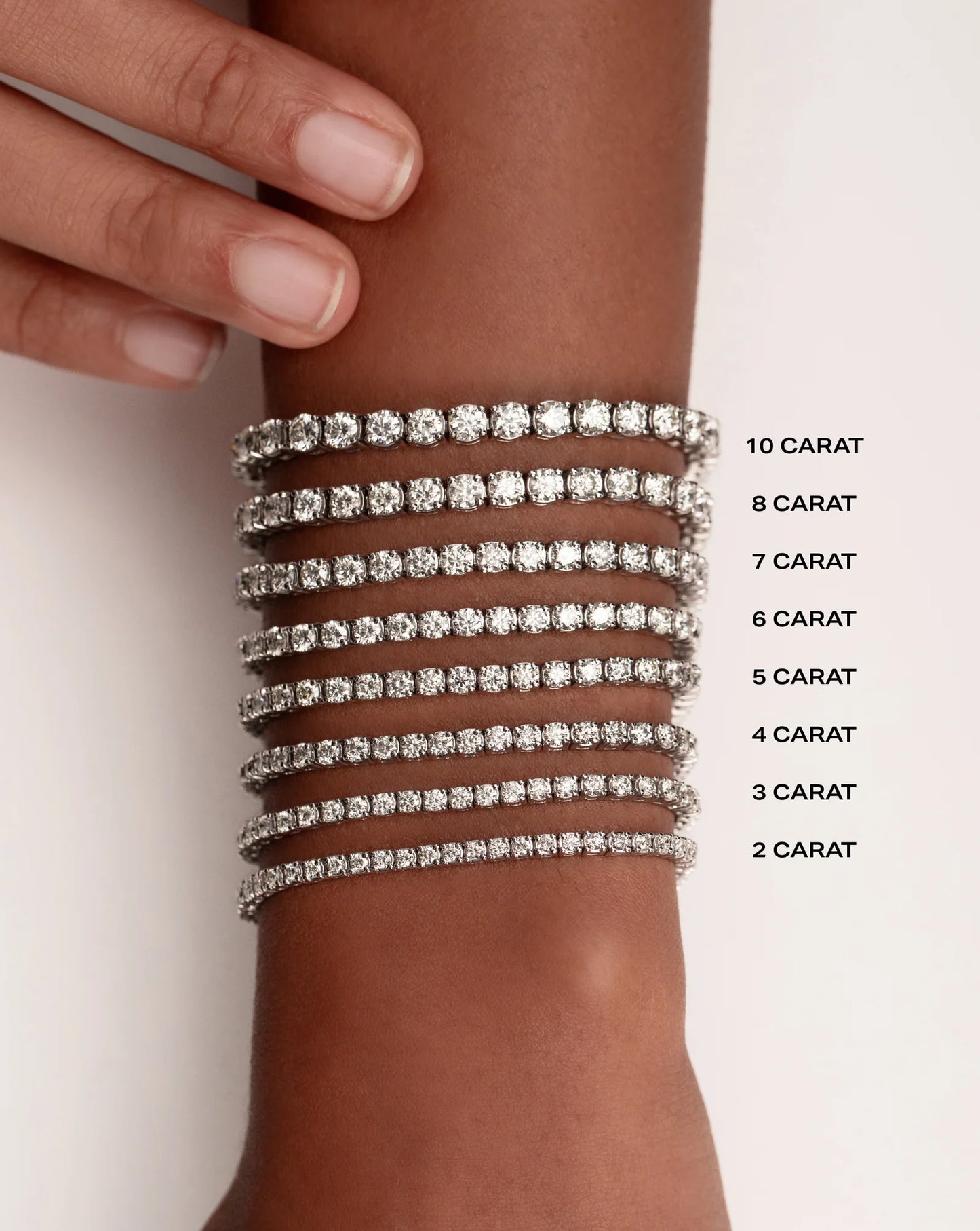 Comparison of different carat sizes of round shape lab diamond tennis bracelets on a hand