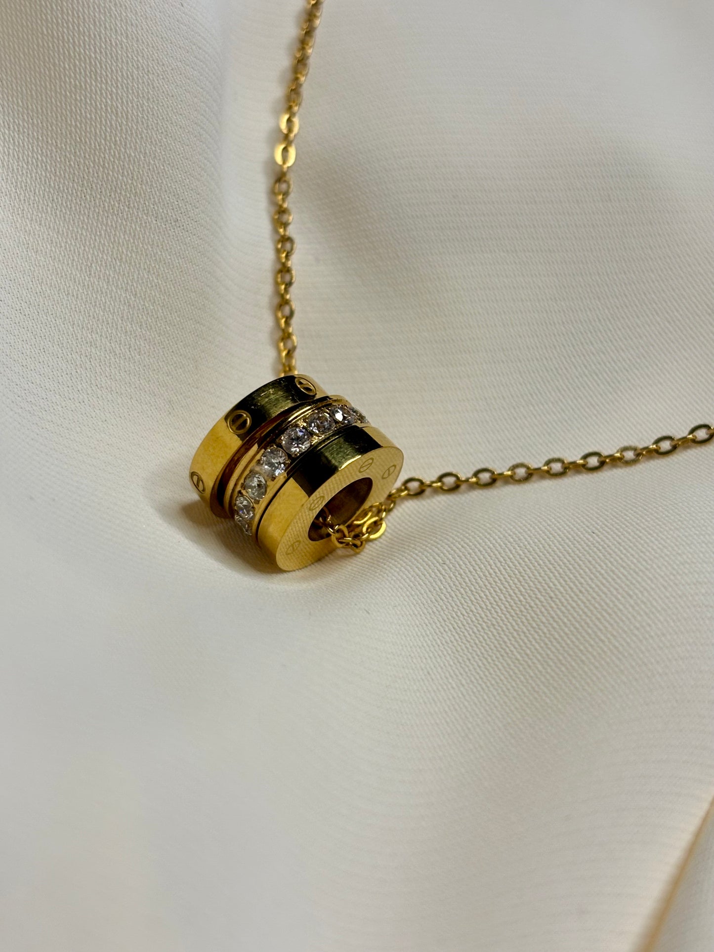 3 rings in pendant form on a gold chain made with Sterling silver and gold plating