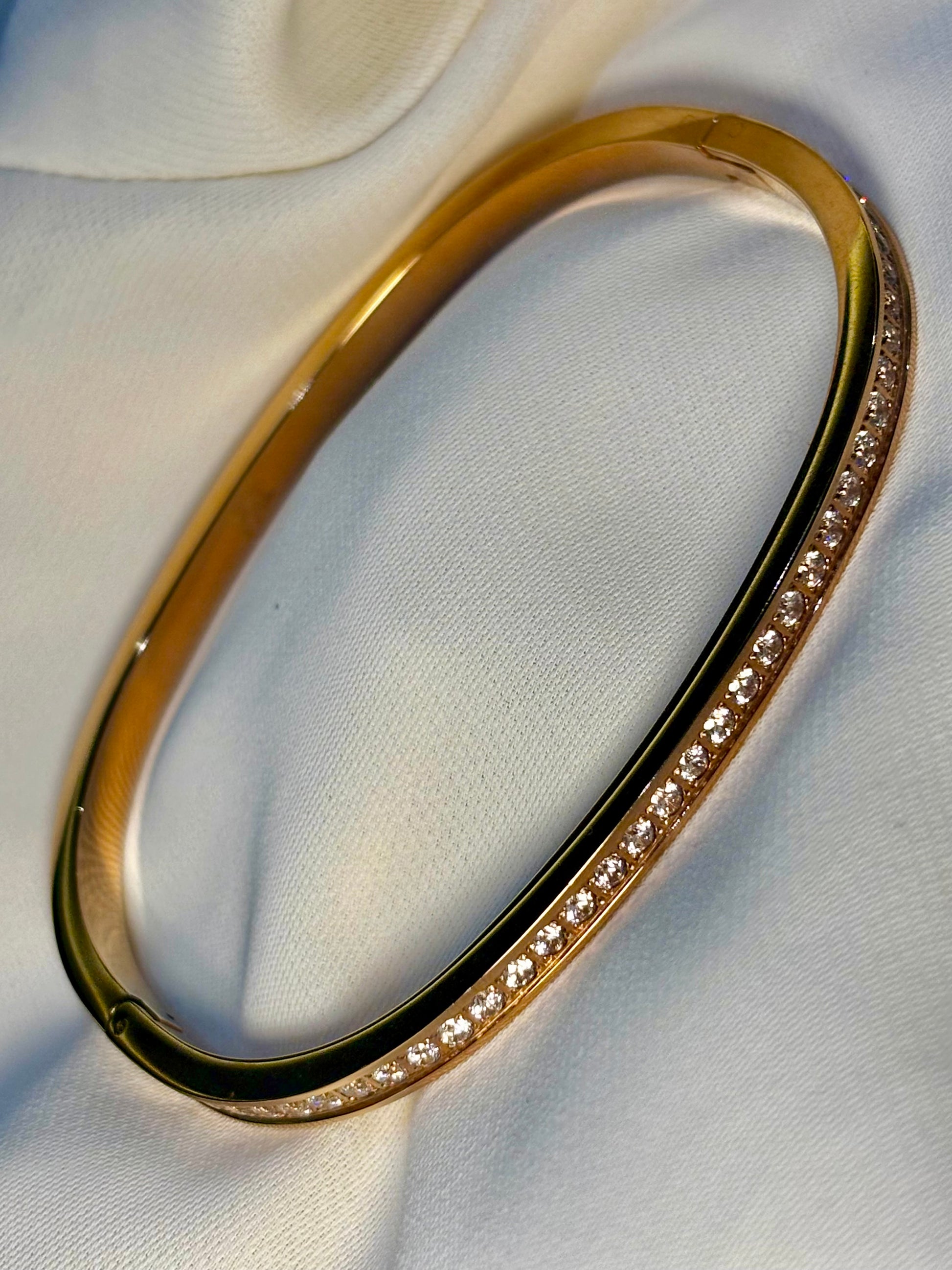 Rose gold tone bangle with moissanite stones made with 92.5 sterling silver in 18 carat rose gold plating. Anti tarnish and waterproof.