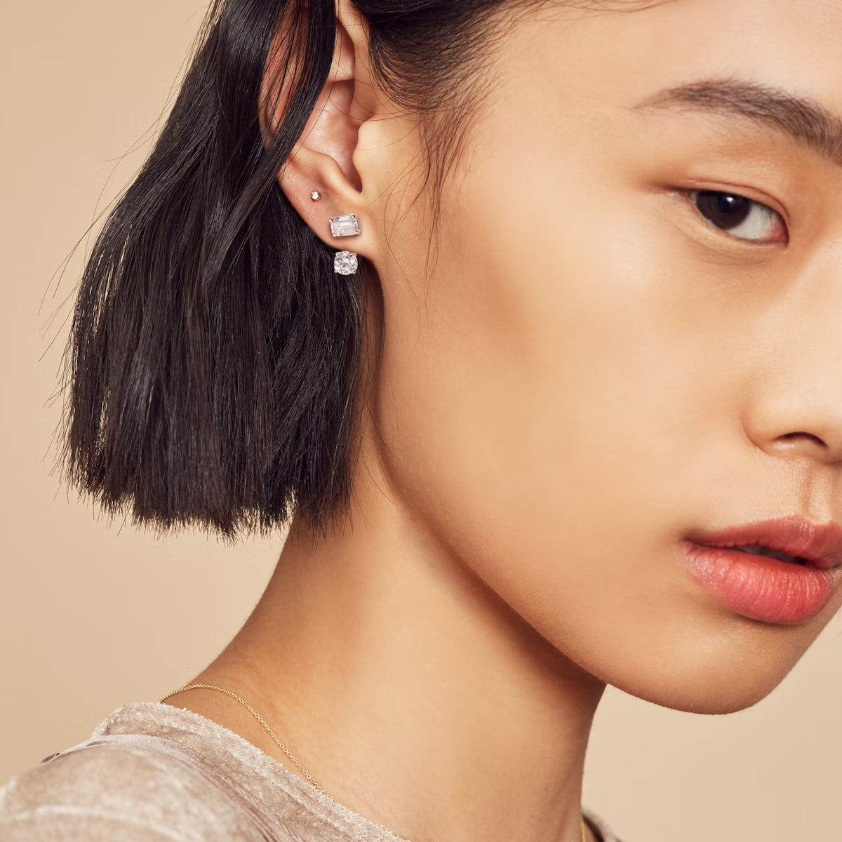 Woman wearing mixed shape drop diamond earrings in white gold