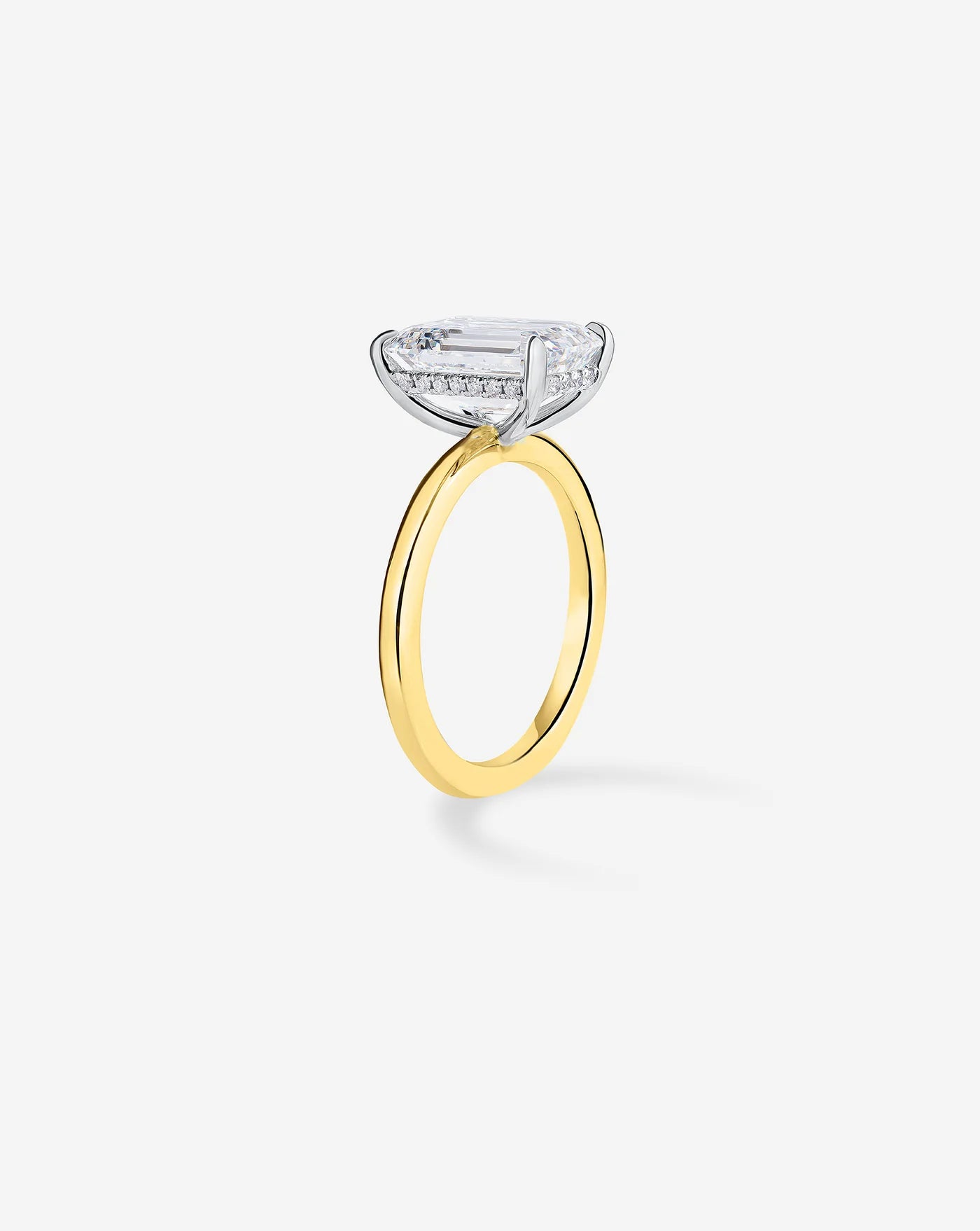 Side view of 3.4 ct emerald cut lab diamond ring in yellow gold band