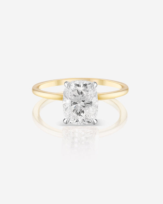 1.50 carat cushion cut lab diamond solitaire ring in a 14kt hallmark yellow gold band.  The diamond is set in a classic 4 prong setting.