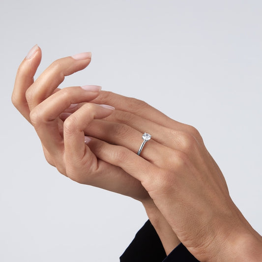 Elegant 1 carat round solitaire lab diamond ring set in 14kt hallmark white gold band. A sustainable and luxurious fine jewellery piece.