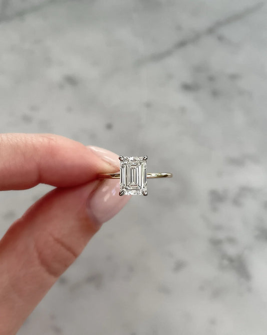 2 carat emerald cut lab diamond solitaire ring set in 14kt hallmark yellow gold band. The ring shows exceptional cut and is in a classic 4 prong setting.