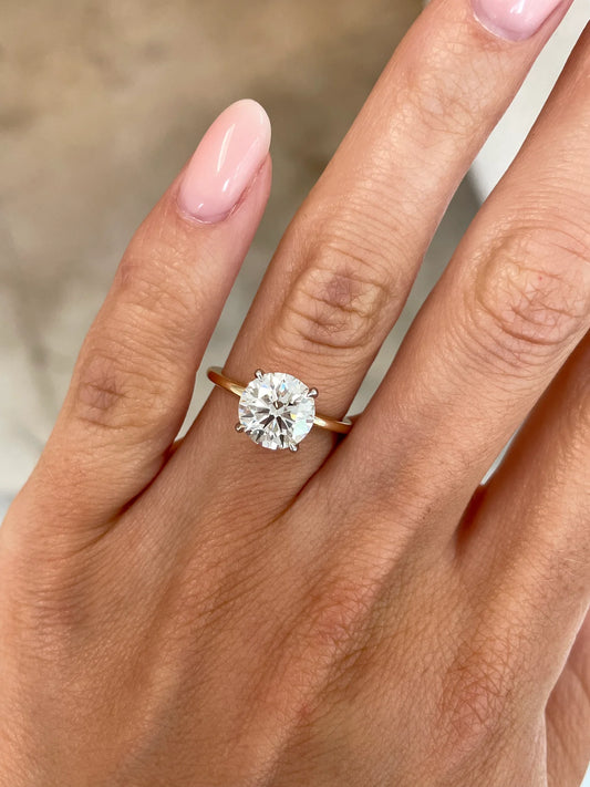 2 carat lab diamond solitaire ring in 14kt hallmark yellow gold band set in a classic 4 prong setting. The image showcases a close up of the diamond, it’s cut and clarity.
