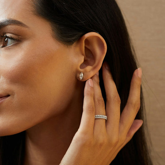 Woman wearing a 2 carat marquise shape diaond solitaire stud earring made in 9kt white gold