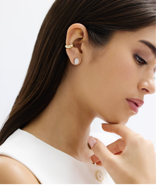 The image shows a woman wearing a 2ct oval shape diamond stud set in 14kt hallmark white gold