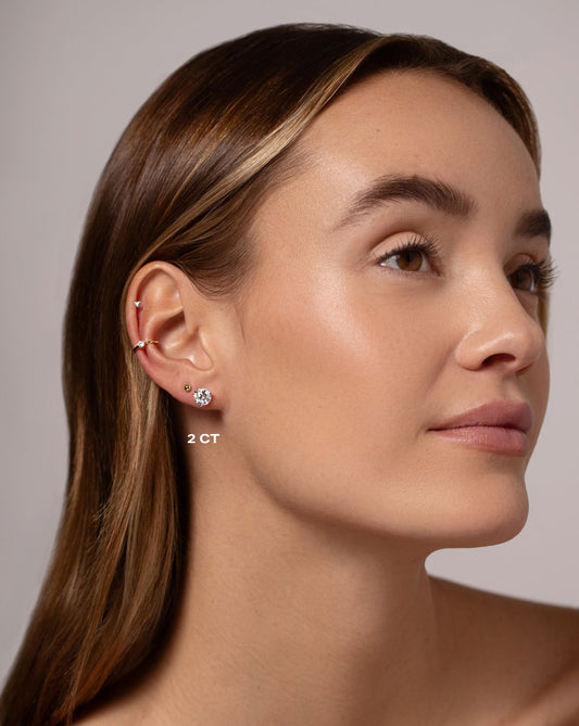 Woman wearing a 2ct round shape diamond solitaire stud made in 14kt white gold