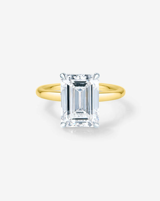 3.4 ct emerald cut lab diamond solitaire ring set in 14kt yellow gold.