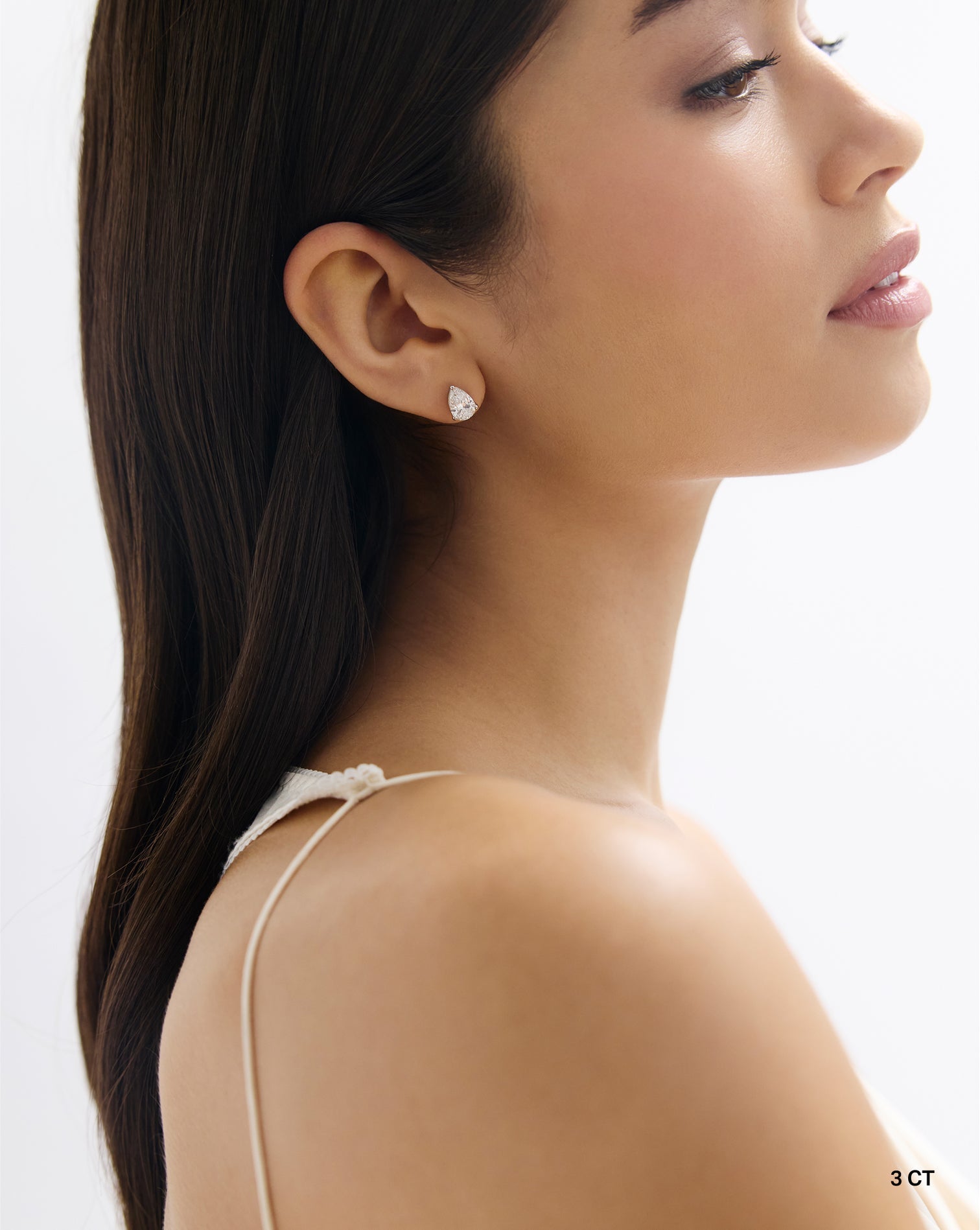 3CT Pear shape lab diamond stud earring in 14kt hallmark gold set in a classic prong setting showcasing perfect brilliance and symmetry 