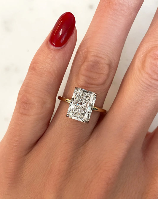 4carat radiant cut lab diamond in a 14kt yellow gold band set with prongs