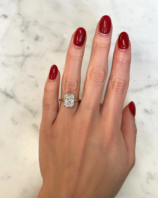 4 carat radiant cut lab diamond solitaire ring in a 14kt hallmark yellow gold band with 4 prongs. The image shows how the ring would look once adorned.