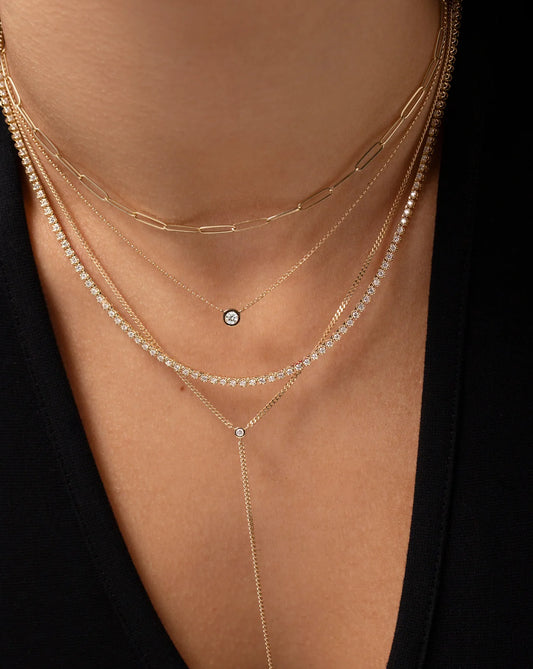 50 pointer round lab diamond pendant in bezel setting made in nine carat hallmark yellow gold stacked with other dainty necklaces