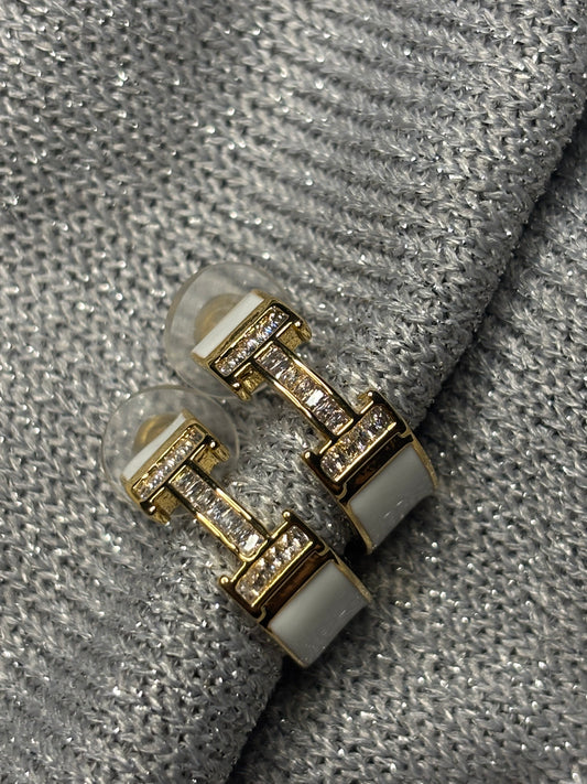 H initial hoop earrings made in 92.5 Sterling silver and 18kt gold plating with moissanite stones and white enamel