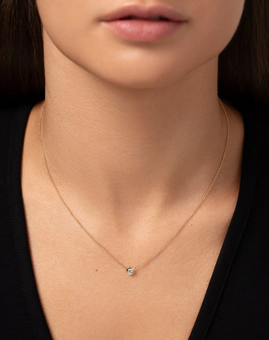 Half carat lab diamond pendant in bezel setting in a dainty hallmark 9kt yellow gold chain necklace.