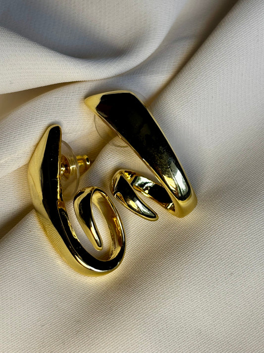 Sculpted twist earrings made with 92.5 sterling silver in 18 karat gold plating. Anti- tarnish and waterproof.