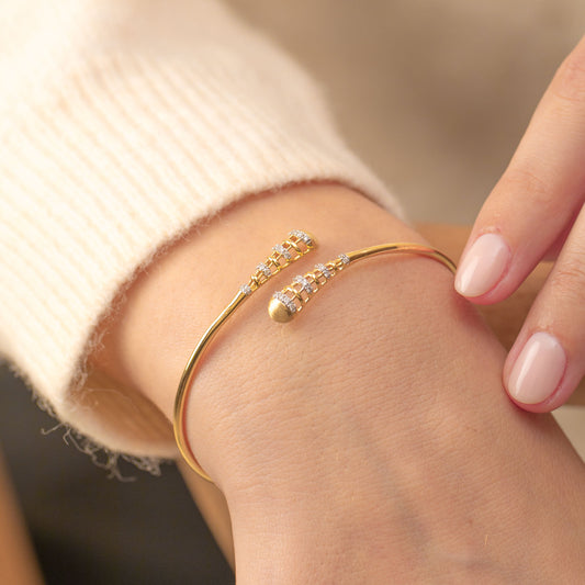 Vintage deco lab diamond and 14kt hallmark yellow gold bracelet displayed on a hand.