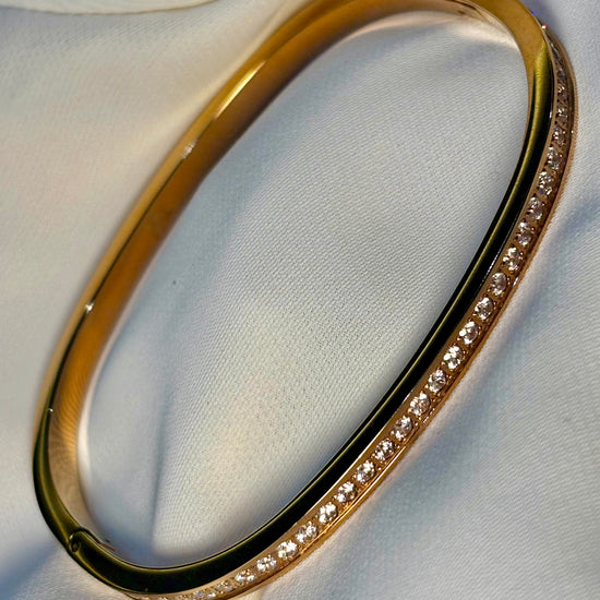 360 View of the half eternity rose gold tone bangle with moissanite stones made with 18 carat rose gold plating, and 92.5 sterling silver. Anti tarnish and waterproof finish.